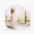 A print depicting a woman standing in a desert landscape with cacti in the background. 