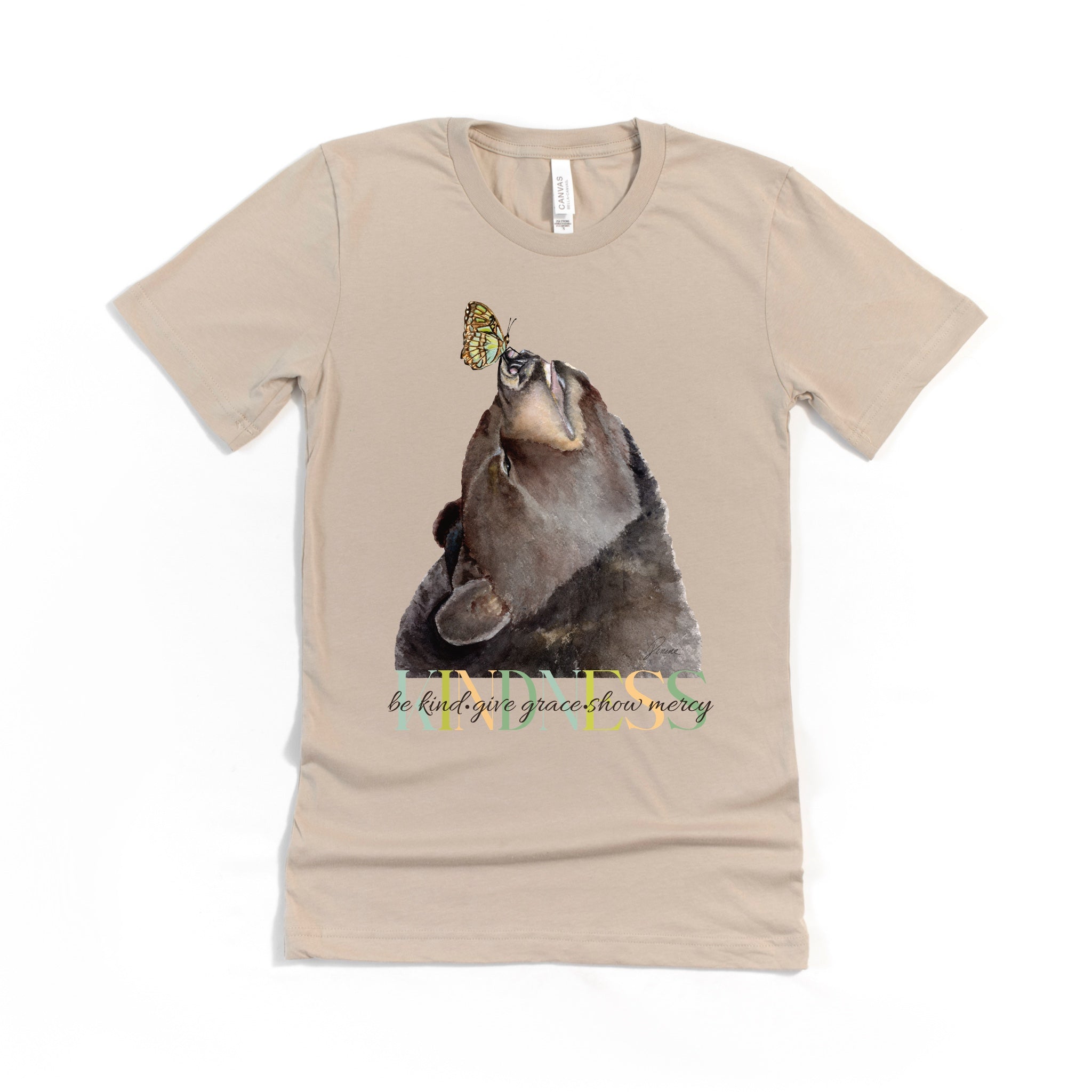 Tan colored t-shirt with of a  bear and butterfly  with 'kindness. be kind. give grace. show mercy' text added to the design.