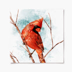 A print of a red cardinal perched on a branch with a snowy background.